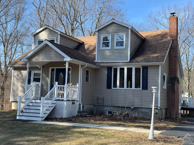 view of front of home featuring a chimney and roof with shingles