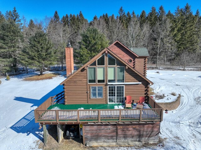 back of house with a wooden deck and a lawn