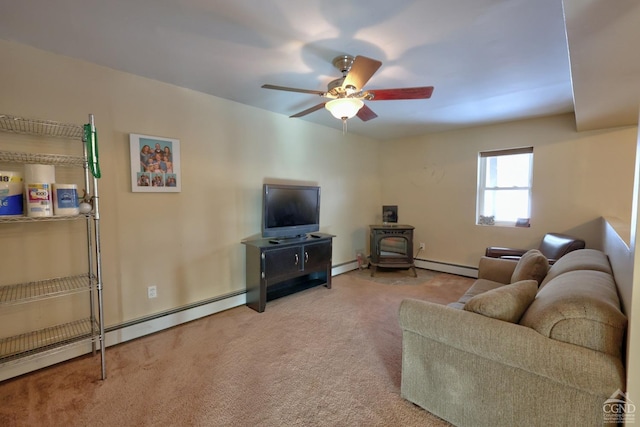 living room with ceiling fan, light colored carpet, a wood stove, and a baseboard heating unit