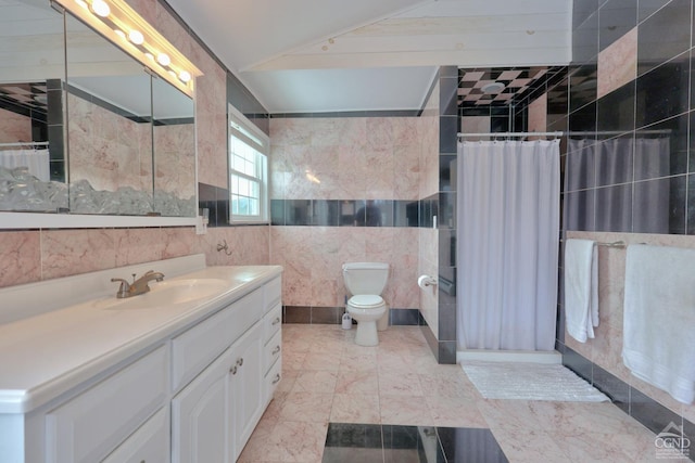 bathroom with lofted ceiling, toilet, vanity, tile walls, and a shower with shower curtain