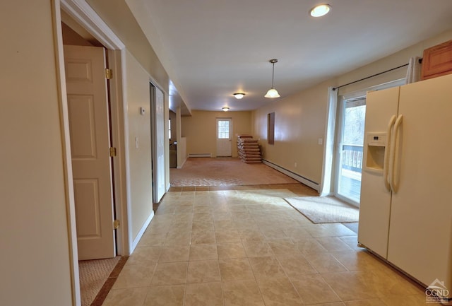 hall featuring a wealth of natural light, light tile patterned floors, and a baseboard radiator