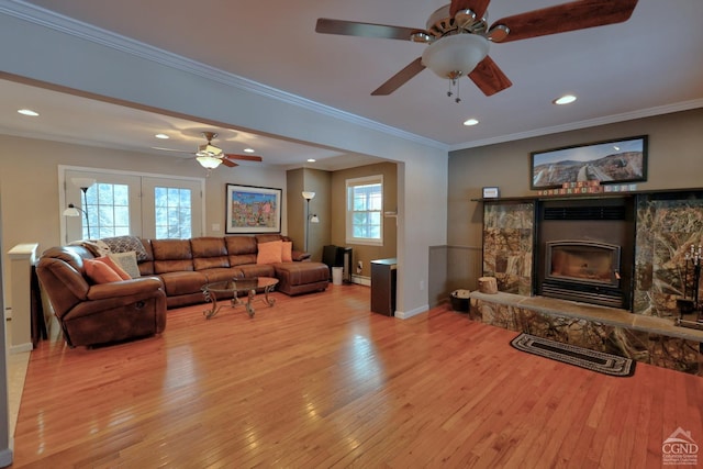 living room with ornamental molding, a fireplace, and a wealth of natural light