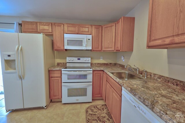 kitchen featuring white appliances, stone countertops, and sink