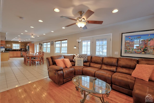 living room with ceiling fan, light hardwood / wood-style flooring, and ornamental molding