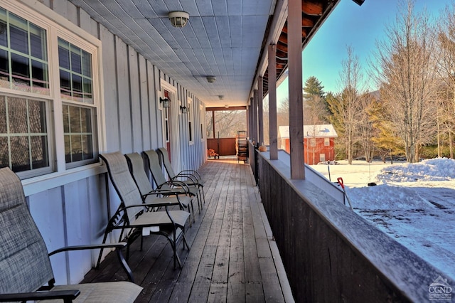 snow covered deck with a porch