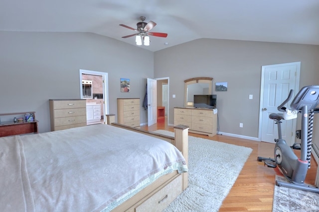 bedroom featuring ceiling fan, light wood-type flooring, connected bathroom, and vaulted ceiling