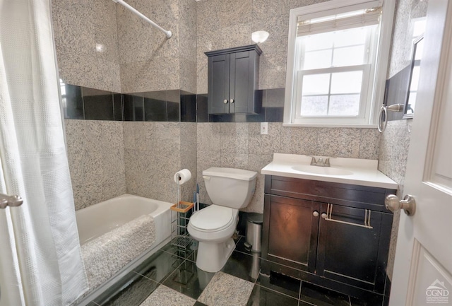 full bathroom with shower / bath combination with curtain, toilet, tile walls, and vanity