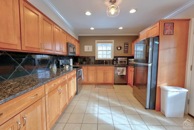 kitchen with appliances with stainless steel finishes, backsplash, ornamental molding, and dark stone countertops