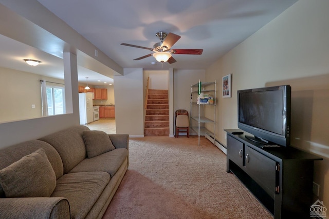 living room featuring ceiling fan, light colored carpet, and a baseboard heating unit