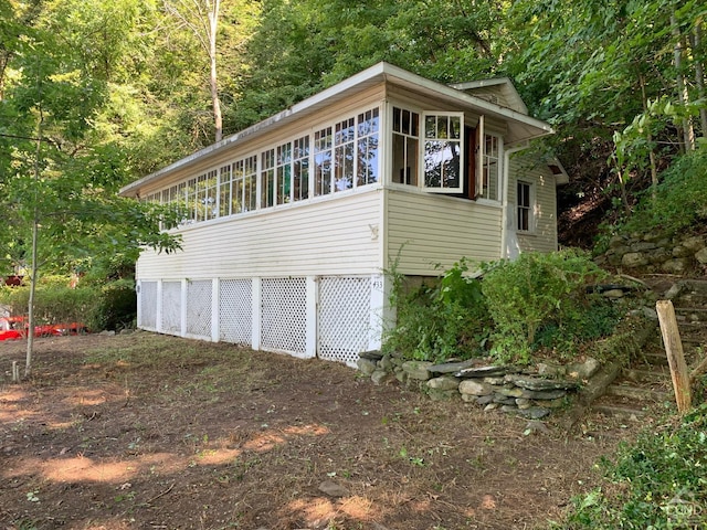 view of side of property featuring a sunroom