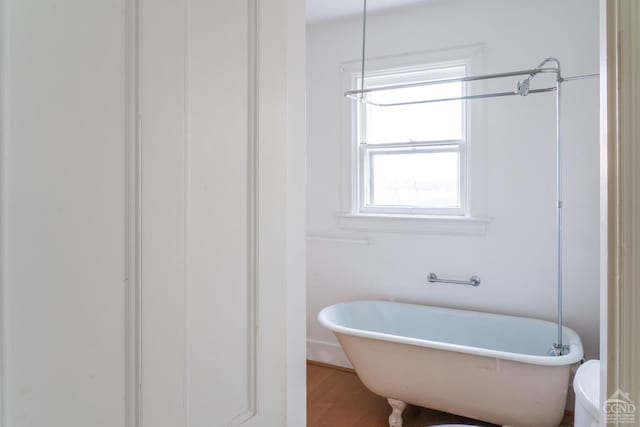 bathroom featuring hardwood / wood-style floors and a tub