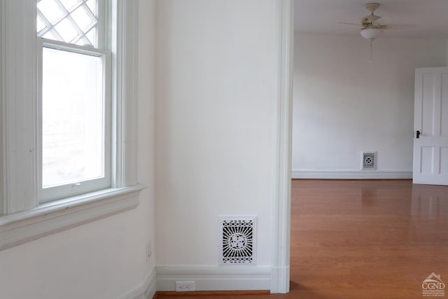 interior space with ceiling fan and hardwood / wood-style floors