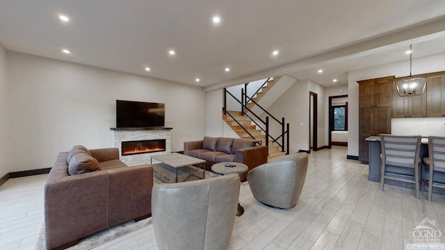 living room with a fireplace and light wood-type flooring