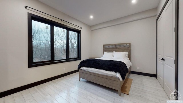 bedroom with a closet and light hardwood / wood-style flooring