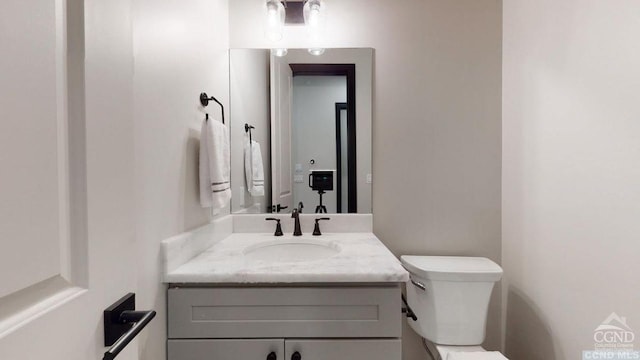 bathroom featuring vanity and toilet