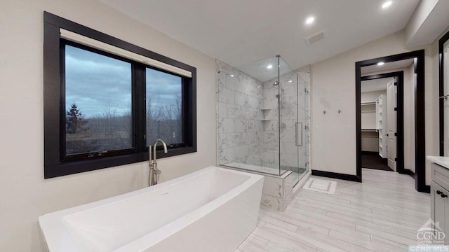 bathroom featuring plus walk in shower, vanity, and vaulted ceiling