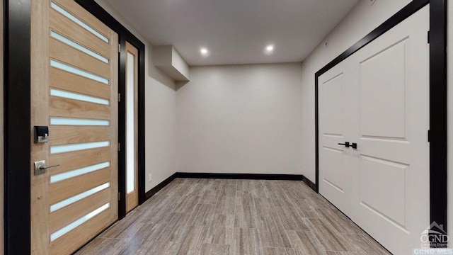 corridor with light hardwood / wood-style floors