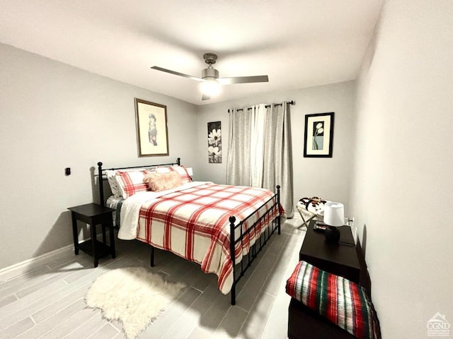 bedroom with ceiling fan and hardwood / wood-style floors