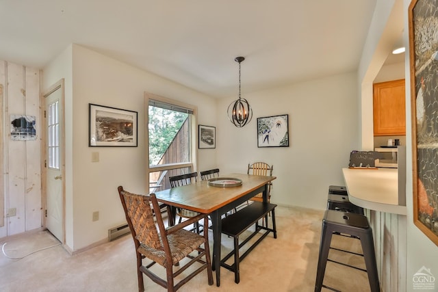 dining space with a notable chandelier, baseboard heating, and light carpet