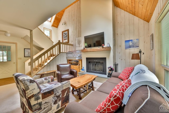 living room featuring light carpet, plenty of natural light, wooden ceiling, and wood walls