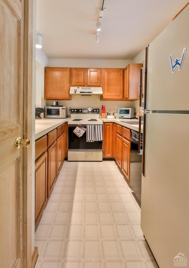 kitchen with white appliances and track lighting