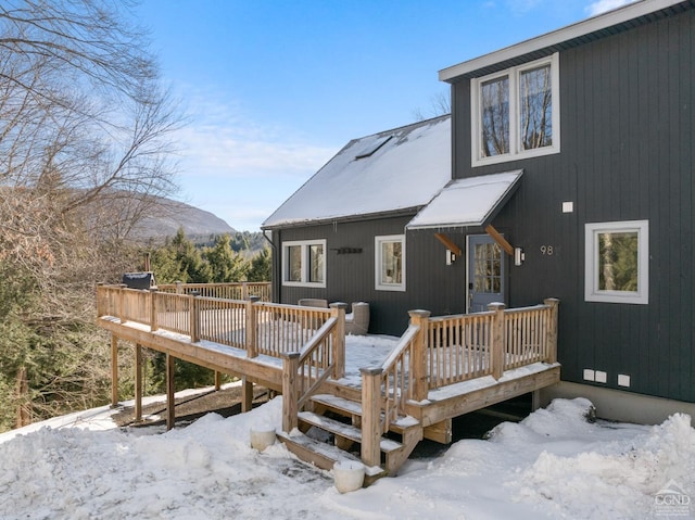 snow covered deck featuring a mountain view