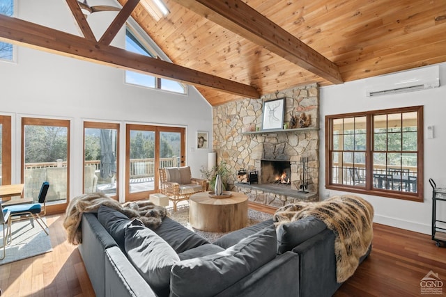 living room with an AC wall unit, dark wood-type flooring, a stone fireplace, and plenty of natural light