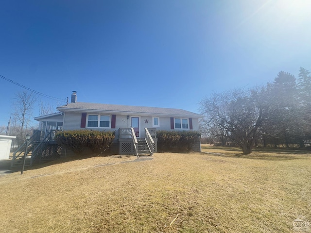 view of front of property with a chimney and a front lawn