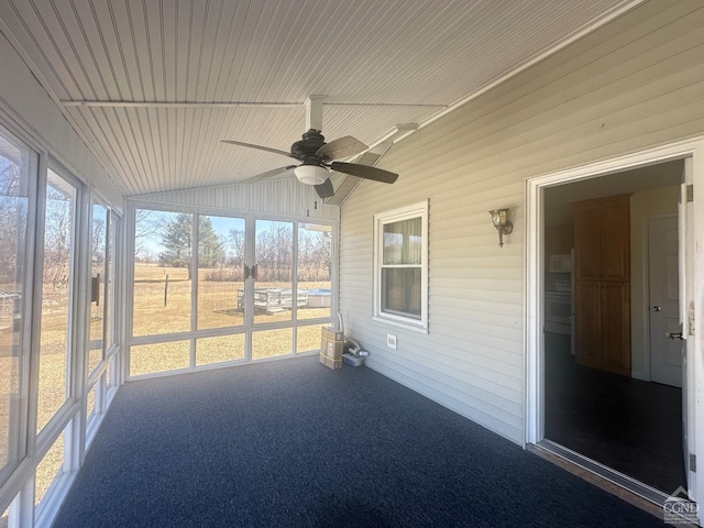 unfurnished sunroom with plenty of natural light, wooden ceiling, a ceiling fan, and vaulted ceiling