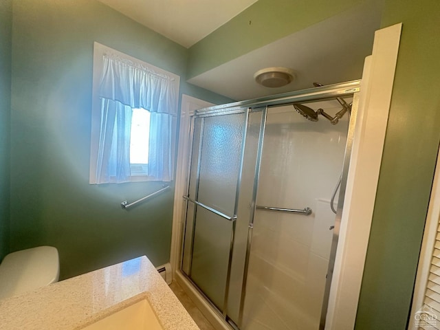 bathroom featuring a baseboard radiator, toilet, and a stall shower