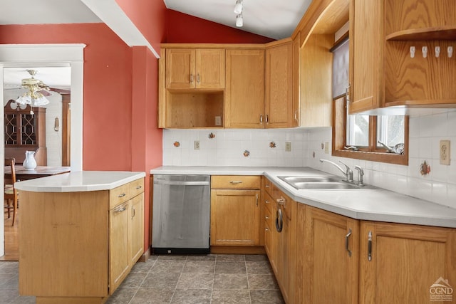 kitchen featuring ceiling fan, dishwasher, sink, backsplash, and lofted ceiling