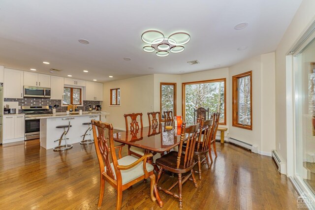 dining area featuring wood-type flooring and a baseboard radiator