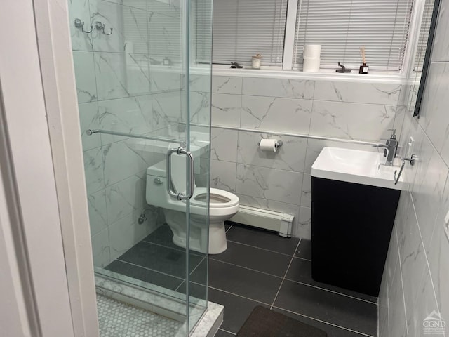 bathroom with a baseboard radiator, tile patterned flooring, toilet, vanity, and tile walls