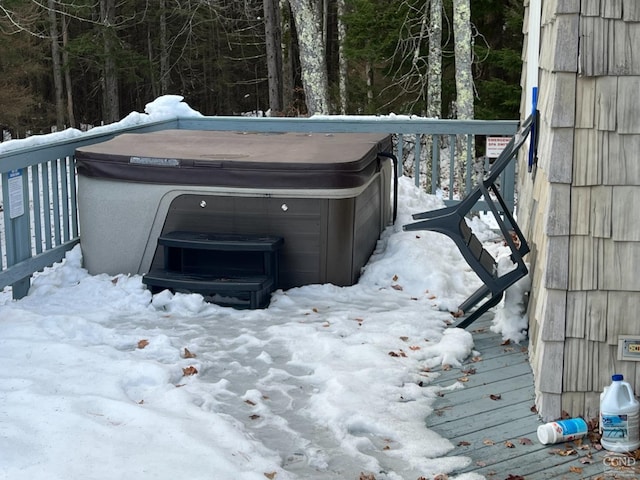 snow covered deck with a hot tub