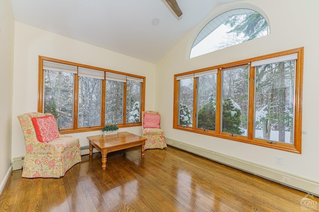 sitting room featuring hardwood / wood-style floors, high vaulted ceiling, and a baseboard heating unit