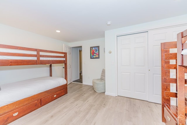 bedroom featuring light wood-type flooring and a closet