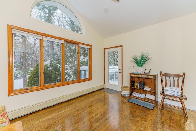 interior space with hardwood / wood-style flooring, high vaulted ceiling, and a baseboard heating unit