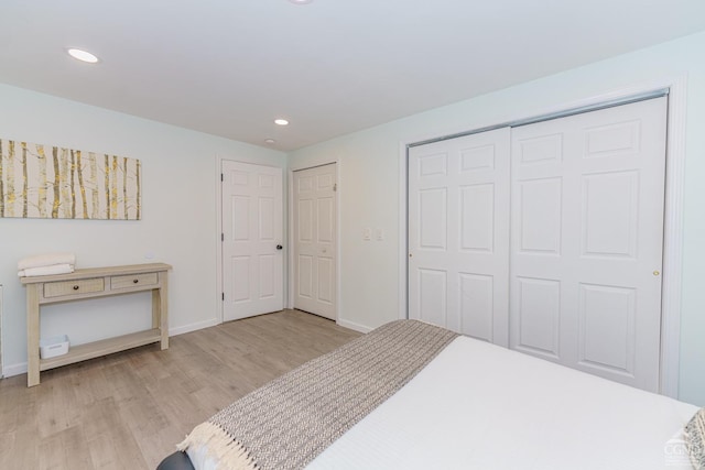 bedroom featuring light hardwood / wood-style floors and a closet