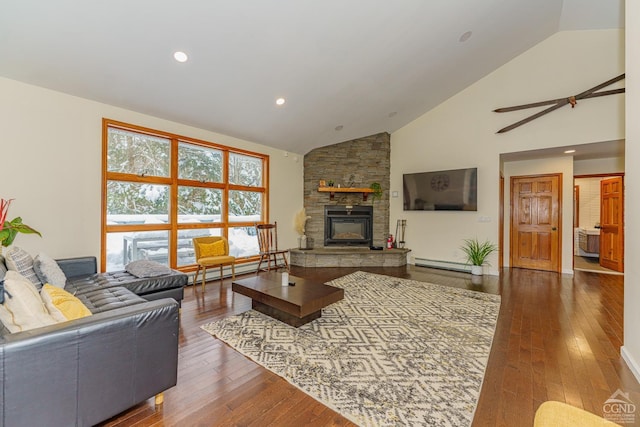 living room with a fireplace, dark hardwood / wood-style floors, baseboard heating, and ceiling fan