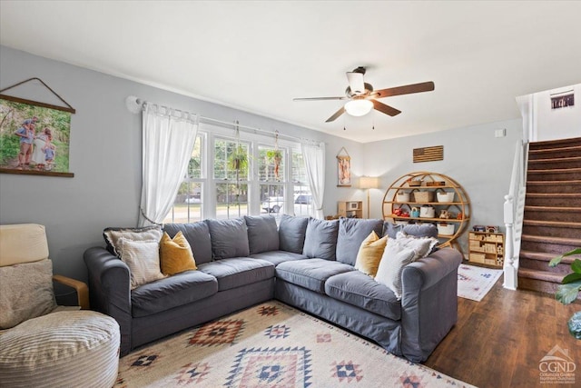 living room featuring dark hardwood / wood-style flooring and ceiling fan