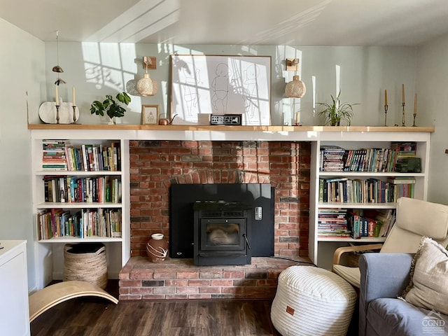 living area featuring hardwood / wood-style floors and a wood stove