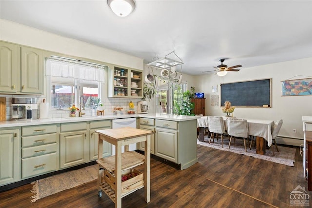 kitchen featuring white dishwasher, ceiling fan, dark hardwood / wood-style floors, and green cabinetry