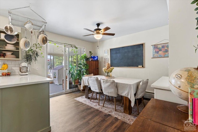 dining space with baseboard heating, ceiling fan, and dark hardwood / wood-style floors