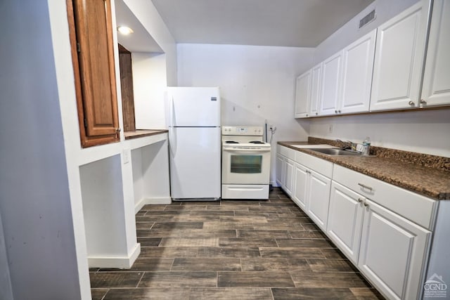 kitchen with dark hardwood / wood-style flooring, white appliances, white cabinetry, and sink