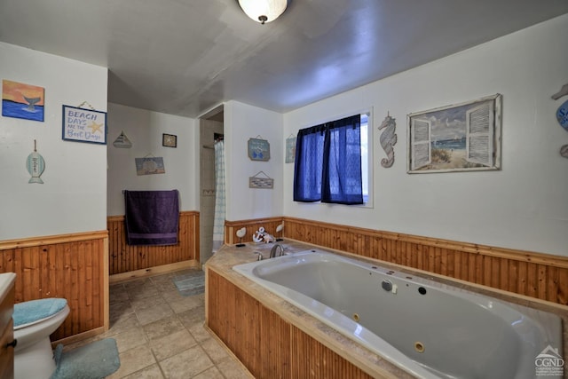 bathroom featuring a washtub and toilet