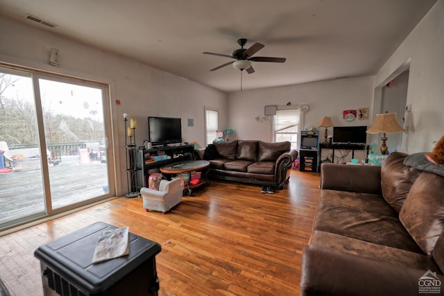 living room with ceiling fan and hardwood / wood-style flooring