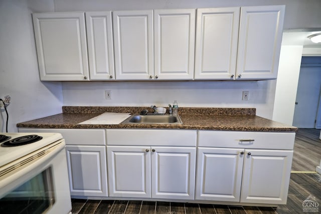 kitchen featuring dark hardwood / wood-style flooring, white cabinetry, and sink