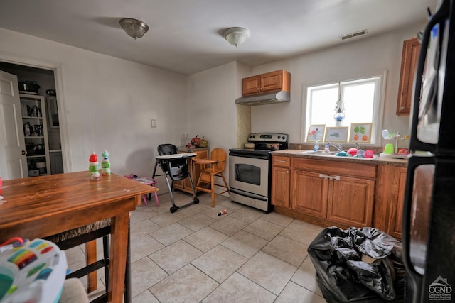 kitchen with black fridge, sink, and stainless steel electric range