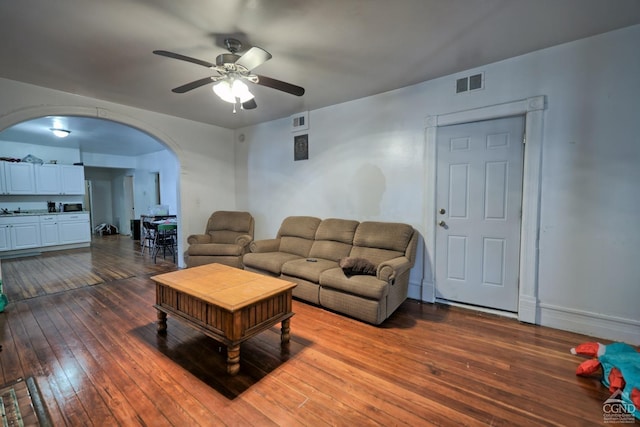 living room featuring wood-type flooring and ceiling fan