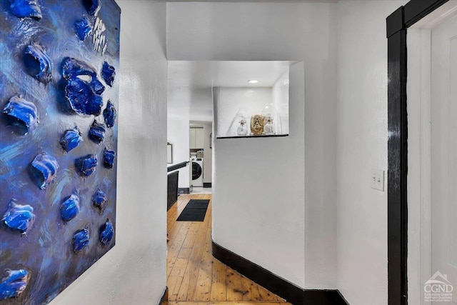 hallway featuring hardwood / wood-style flooring and washer / clothes dryer